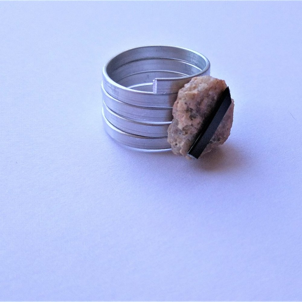 Amitirne white crystal quarts set in black and silver swirls of aluminum